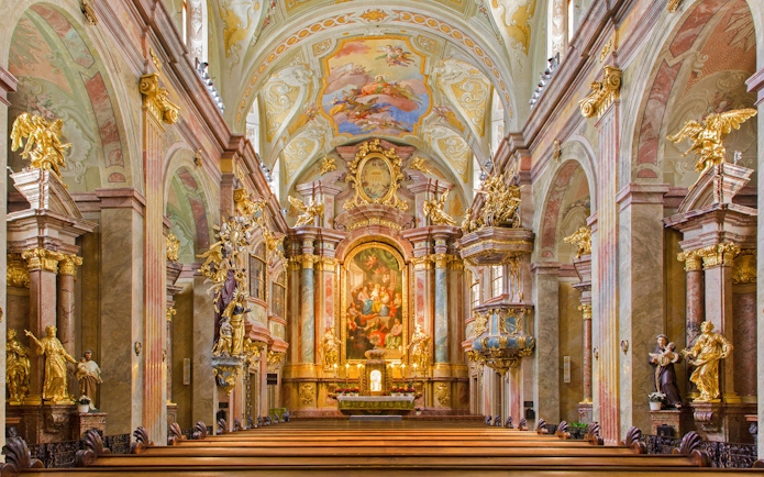 Interior of St Anne's Church with ornate altar and detailed frescoes.