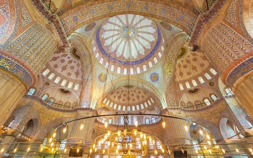 Blue Mosque interior with ornate domes and intricate patterns, Istanbul.