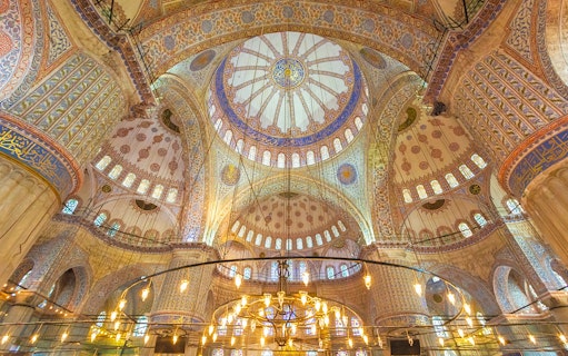 Blue Mosque interior with ornate domes and intricate patterns, Istanbul.