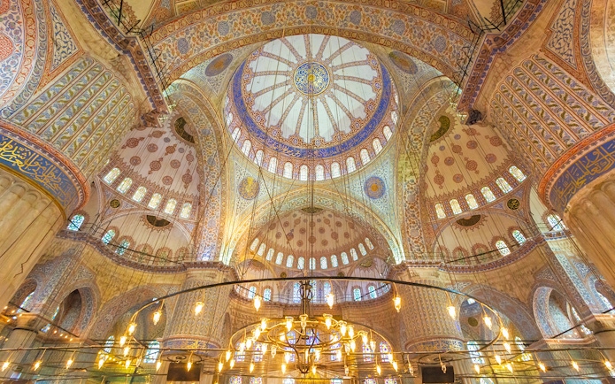 Blue Mosque interior with ornate domes and intricate patterns, Istanbul.