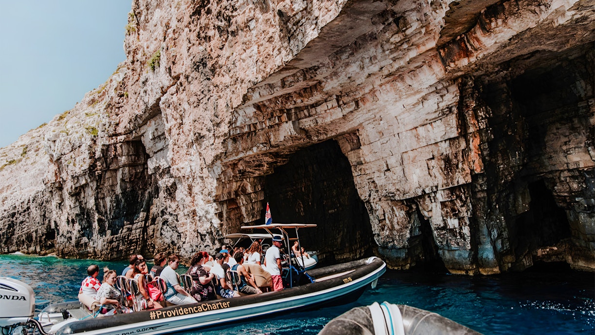 Speedboat tour entering Blue Cave on Blue Lagoon & 5 Islands trip.