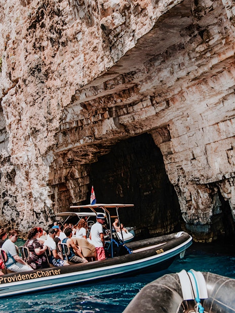 Speedboat tour entering Blue Cave on Blue Lagoon & 5 Islands trip.