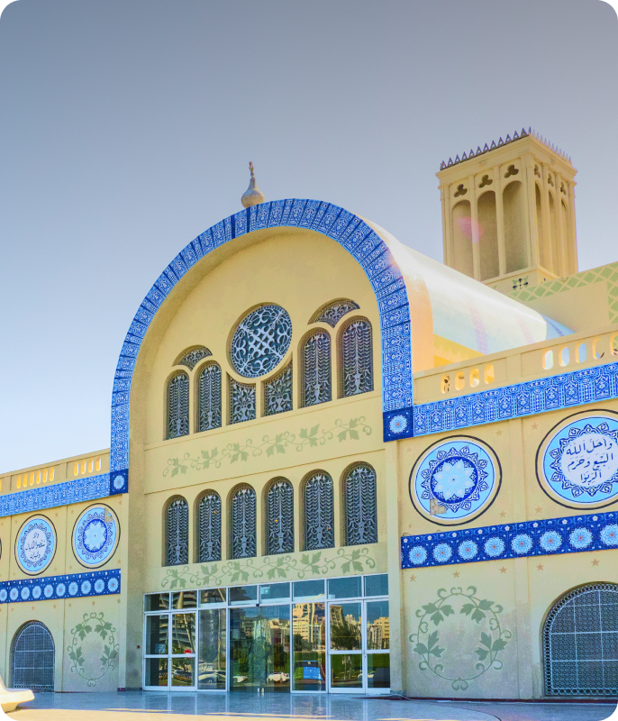 Sharjah Central Souq building with blue tile details and arched windows.