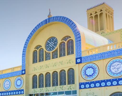Sharjah Central Souq building with blue tile details and arched windows.
