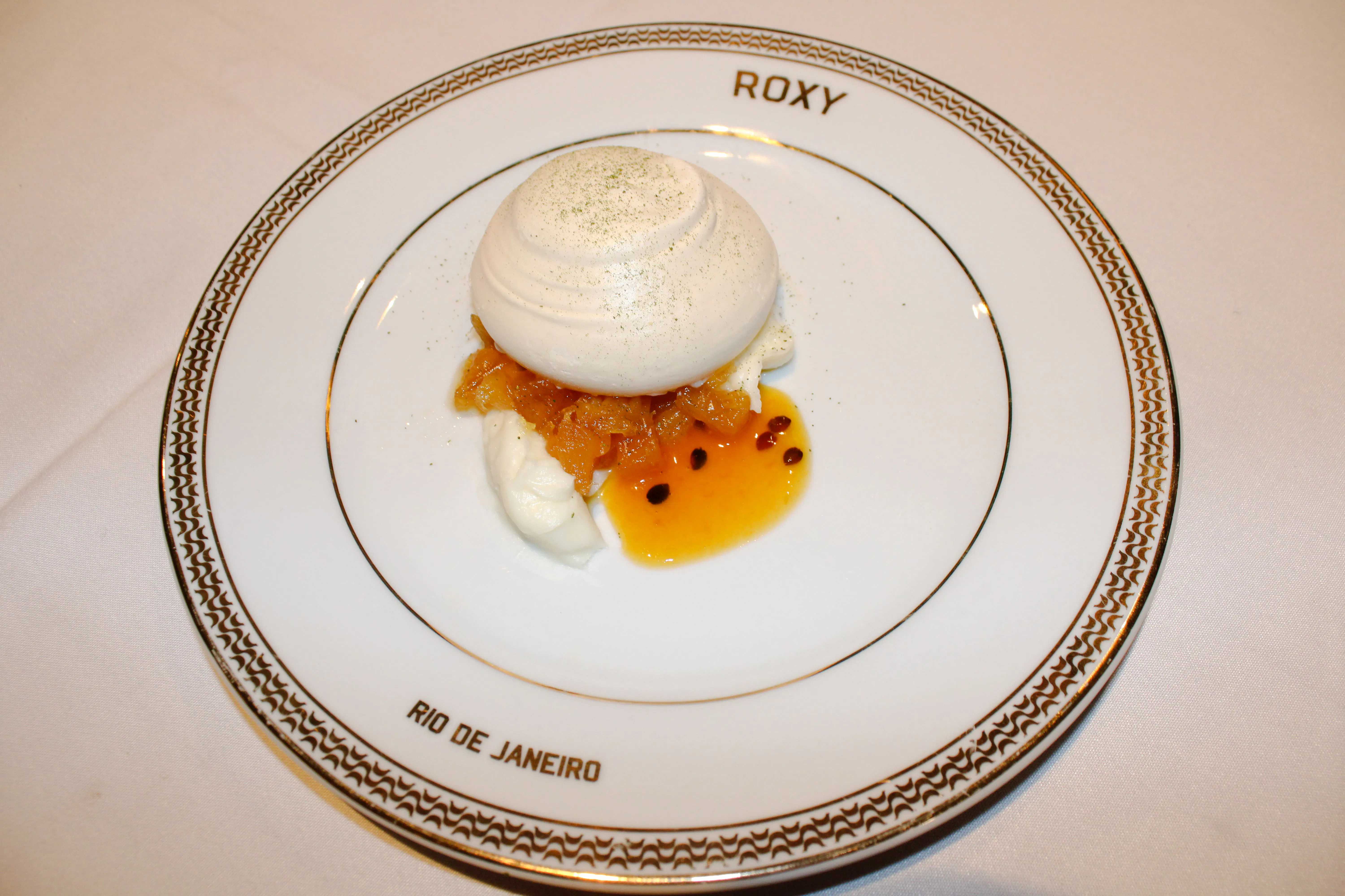 Dessert served at Roxy Dinner Show in Rio de Janeiro, featuring meringue and fruit sauce.