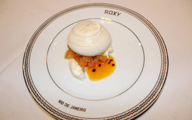 Dessert served at Roxy Dinner Show in Rio de Janeiro, featuring meringue and fruit sauce.