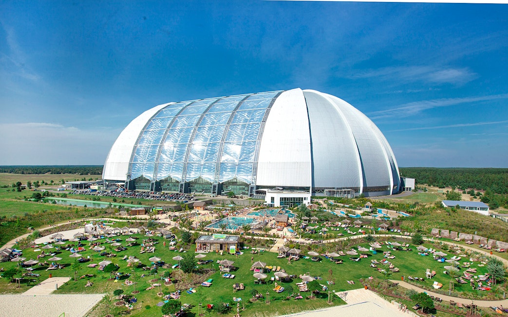 Tropical Islands Resort dome with outdoor pool and sunbathing area in Germany.