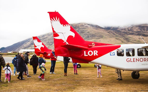 Scenic flight passengers boarding at Queenstown Airport for Milford Sound tour.