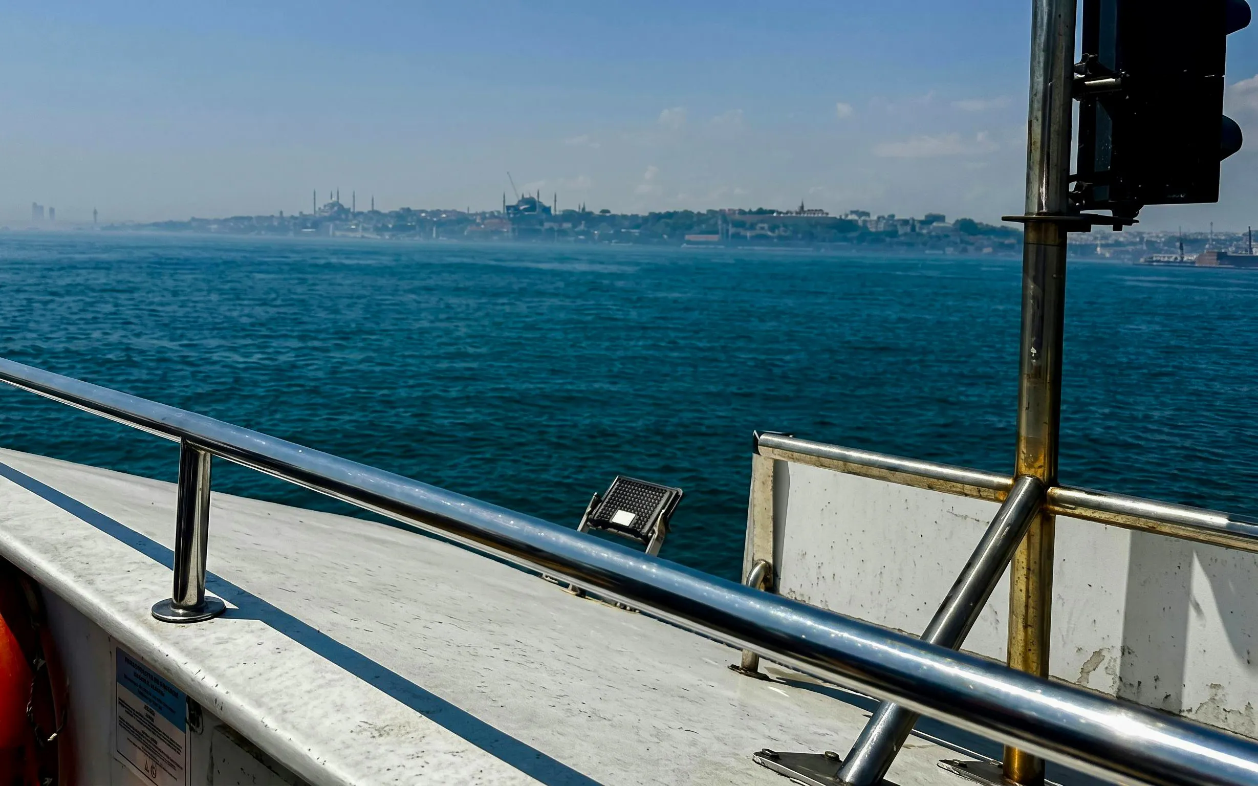 Boat view of Istanbul skyline across the Bosphorus during a food tour.