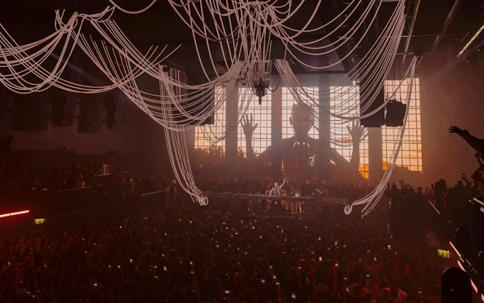 Crowd at Anyma presents AEDEN UNVRS performance, Ibiza, with dynamic stage visuals.