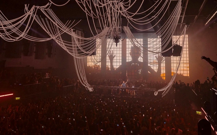 Crowd at Anyma presents AEDEN UNVRS performance, Ibiza, with dynamic stage visuals.