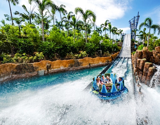 Raft descending the Infinity Falls river rapids ride at SeaWorld Orlando.