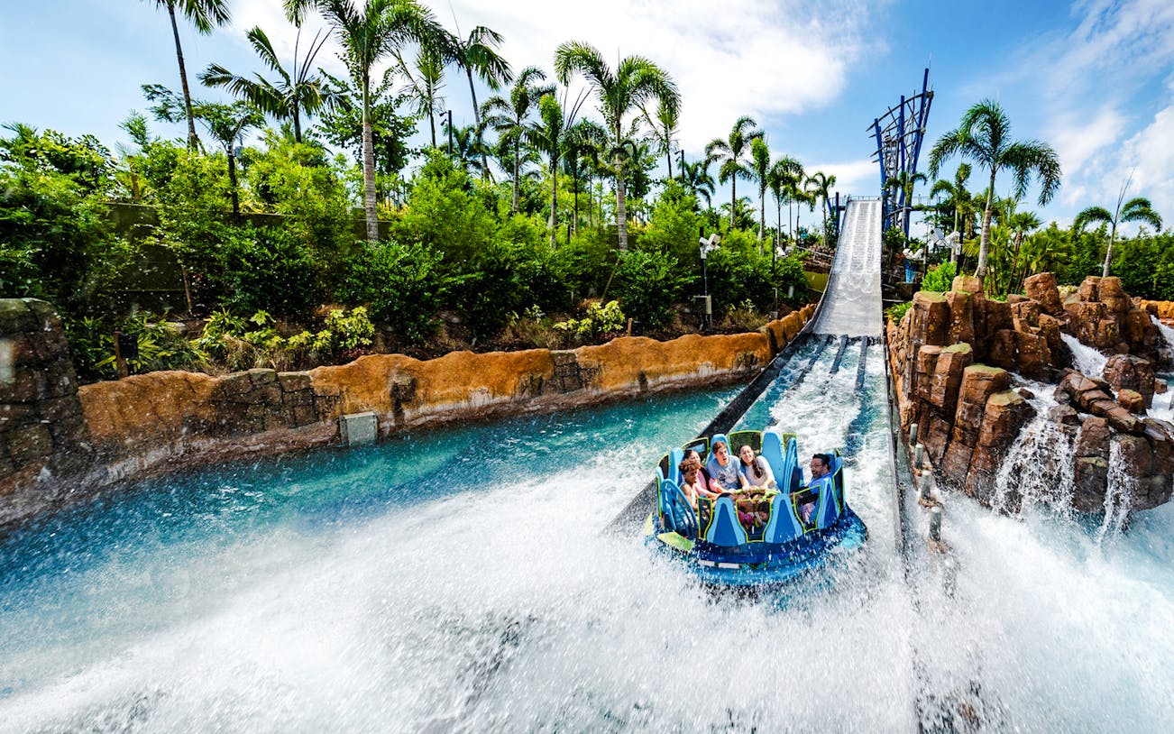 Raft descending the Infinity Falls river rapids ride at SeaWorld Orlando.
