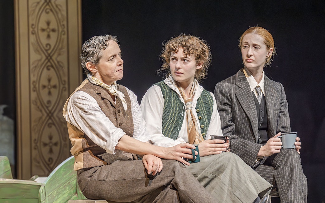 Artists performing in Grace Pervades West End show, seated and holding mugs.