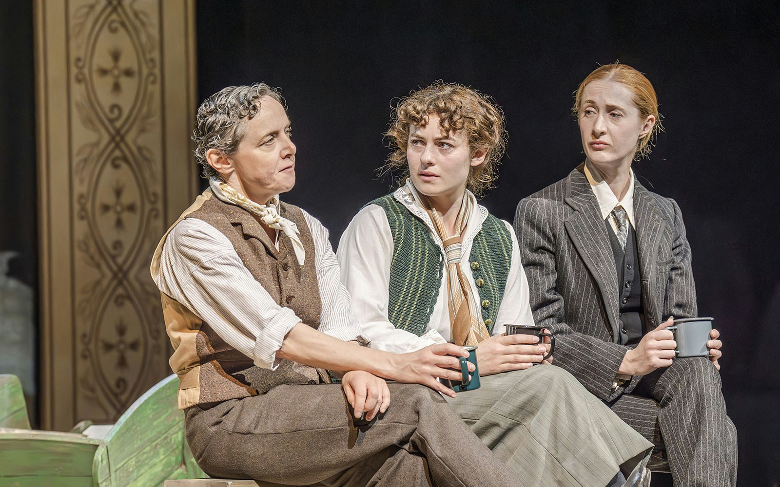 Artists performing in Grace Pervades West End show, seated and holding mugs.