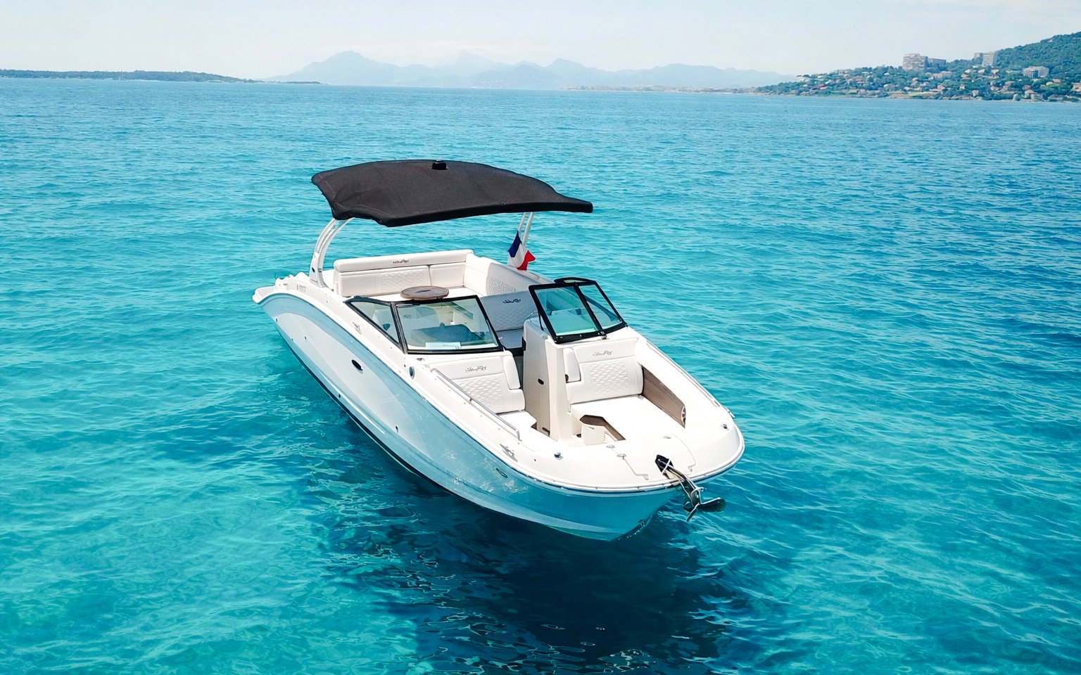 Private boat on clear blue waters near Lérins Islands, Cannes.