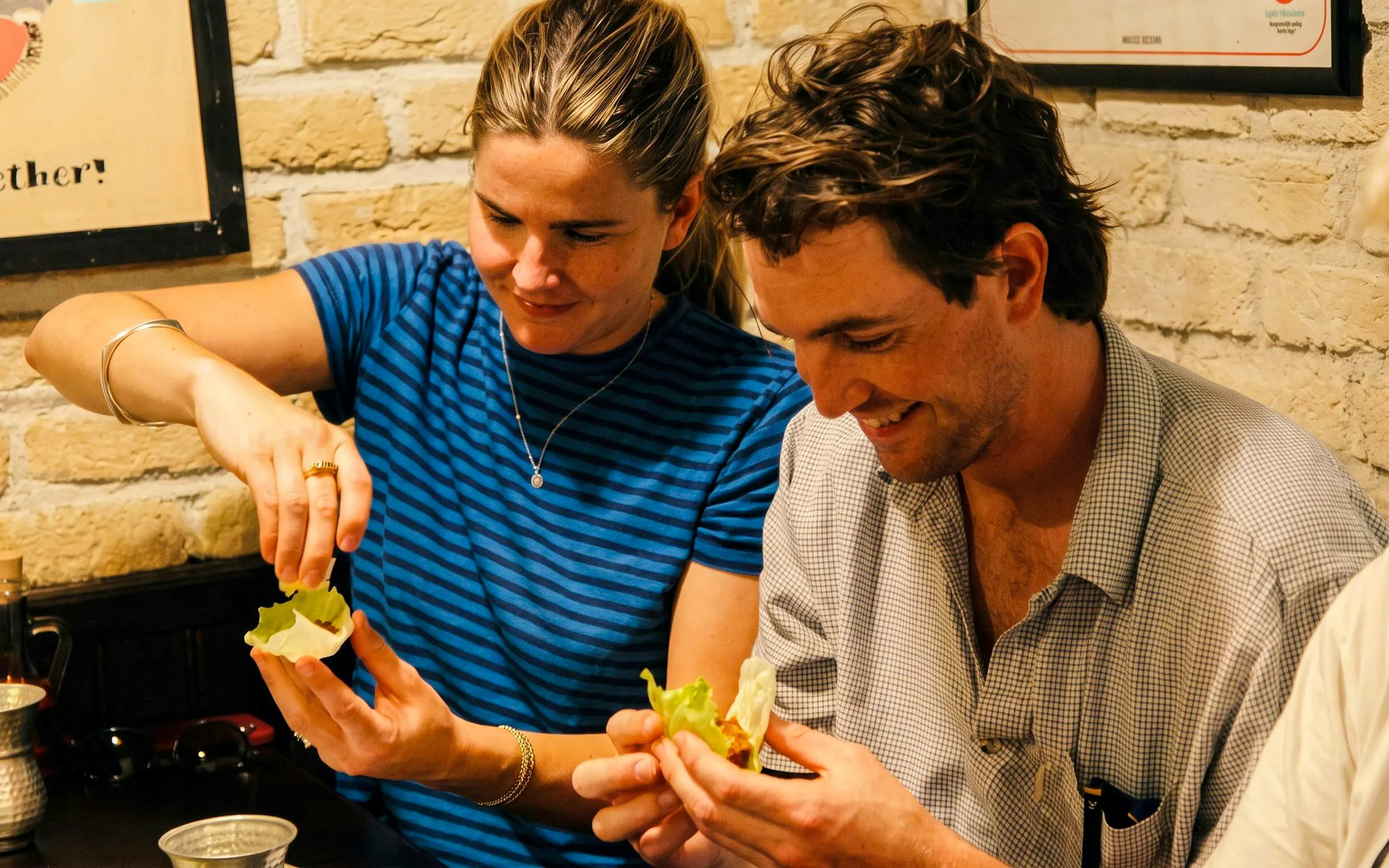 Couple enjoying hands-on cooking experience on Istanbul food tour.