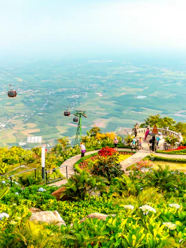 Cable cars over lush gardens at Sun World Ba Den Mountain, Vietnam.