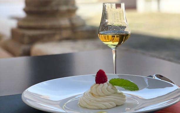 Dessert with raspberry and wine glass at Museum of Brunello di Montalcino.