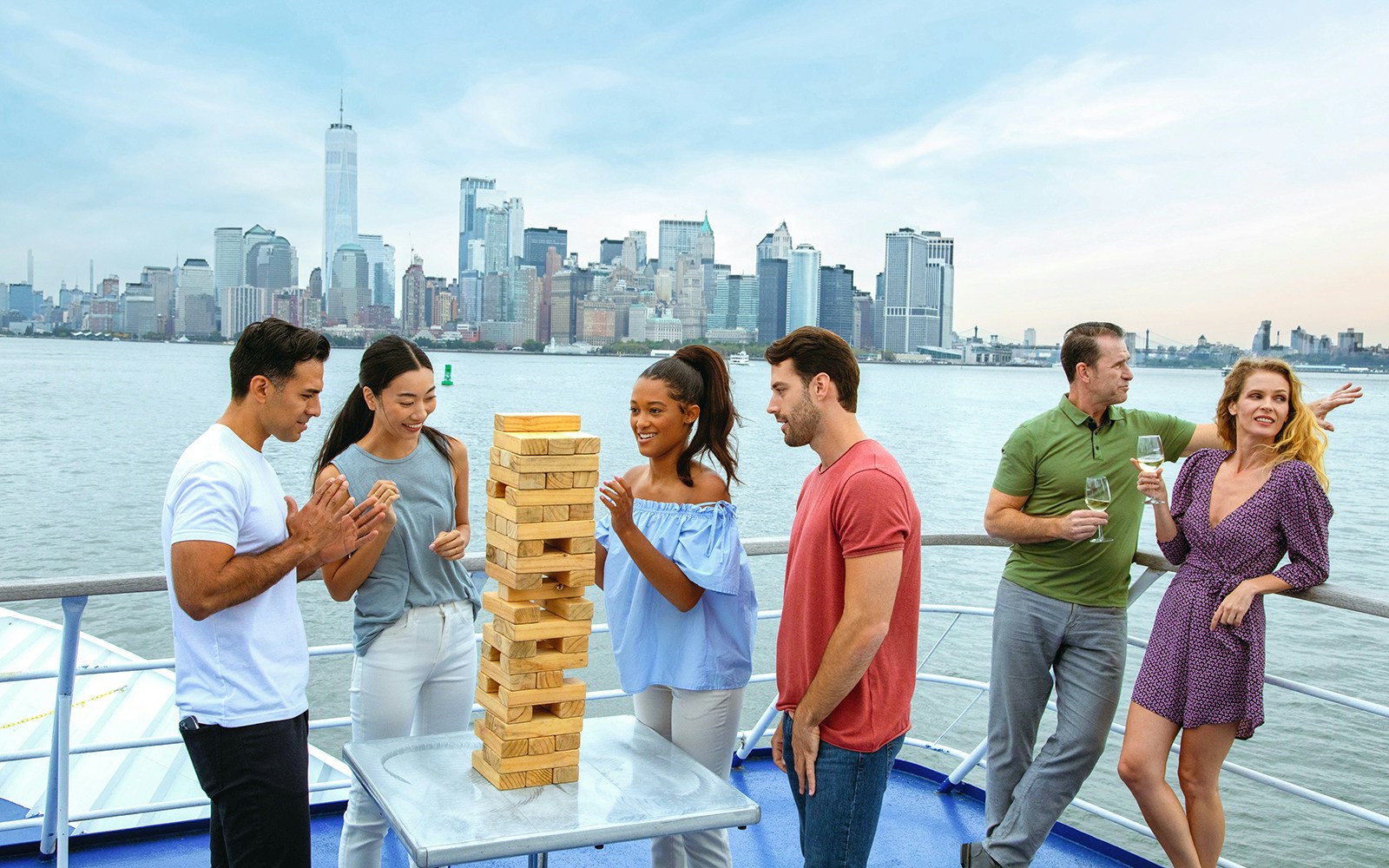 Group playing Jenga on deck during New York City lunch cruise.