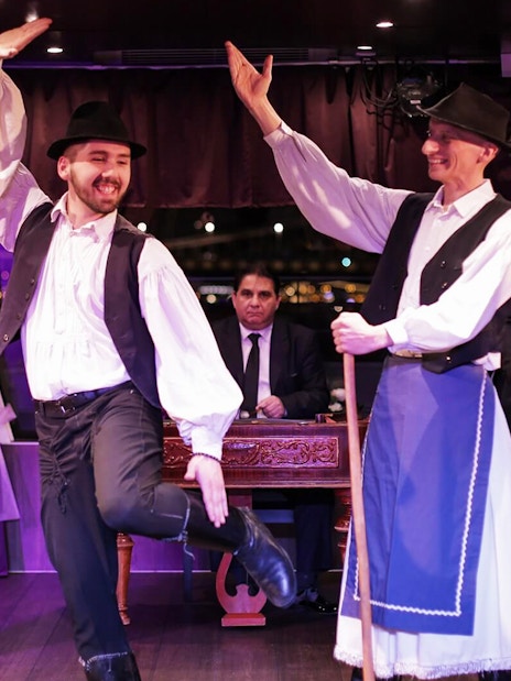 Budapest dinner cruise with folk dancers and musicians performing on stage.
