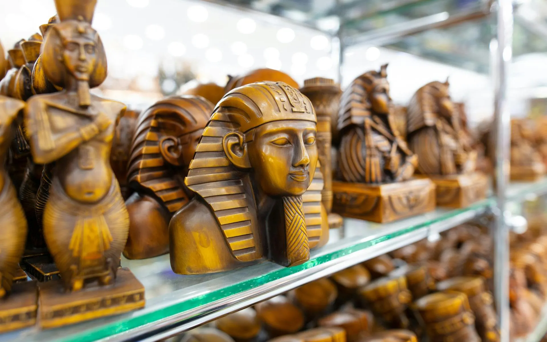 Wooden pharaoh statues on display in Sharm El-Sheikh market.