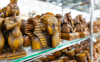 Wooden pharaoh statues on display in Sharm El-Sheikh market.