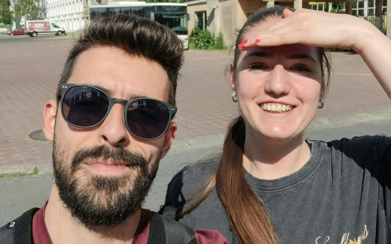 Two people smiling during a self-guided city exploration in Brașov.