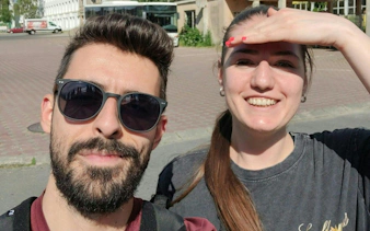 Two people smiling during a self-guided city exploration in Brașov.