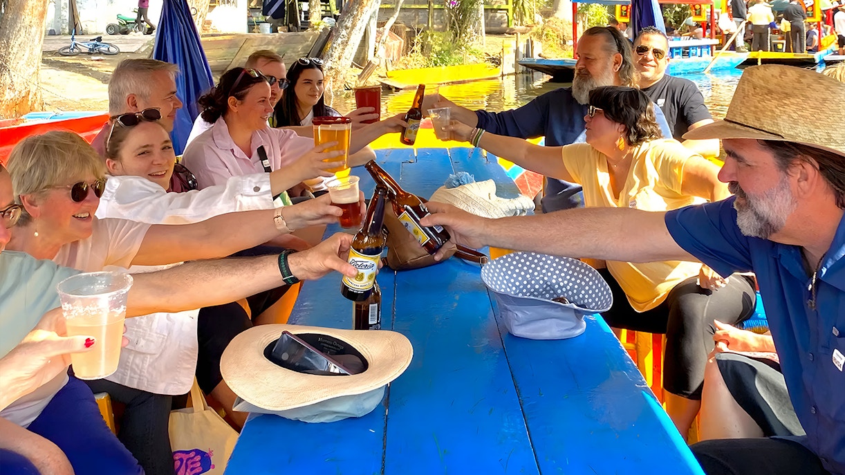 Guests on Trajinera Party boat in Xochimilco enjoying unlimited drinks and food.