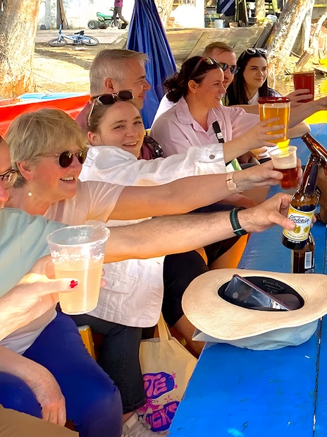 Guests toasting with drinks on a Trajinera party boat in Xochimilco.