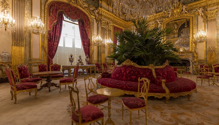 Louvre Museum Richelieu wing interior with sculptures and furniture exploring exhibits.