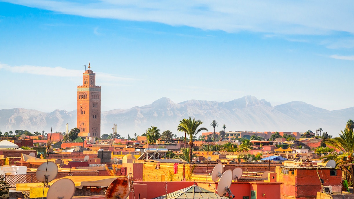 Koutoubia Mosque tower with Atlas Mountains in Marrakech, Morocco.
