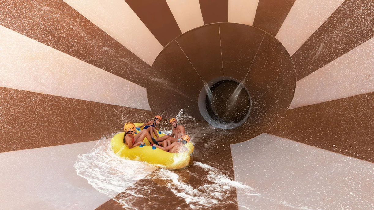 Visitors on a raft ride through the Toboganxote slide at Xplor Park.