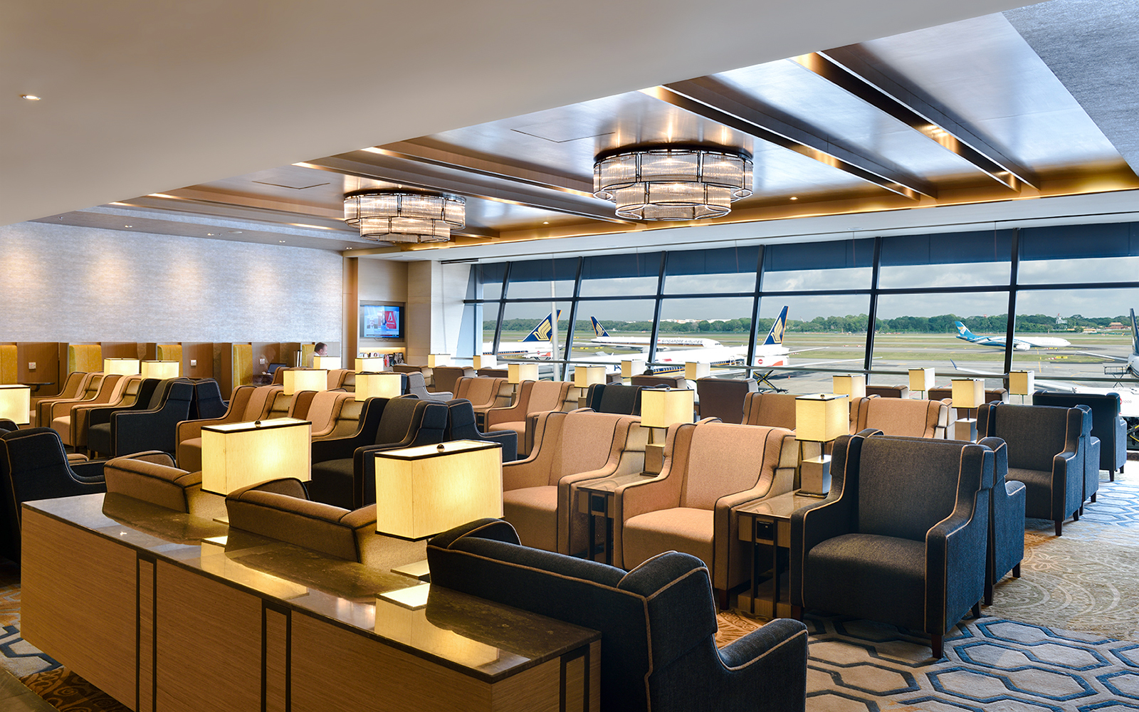 Plaza Premium Lounge seating area with runway view at Singapore airport.
