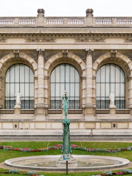 Frida Kahlo Exhibition at Petit Palais, Paris with ornate facade and garden statue.