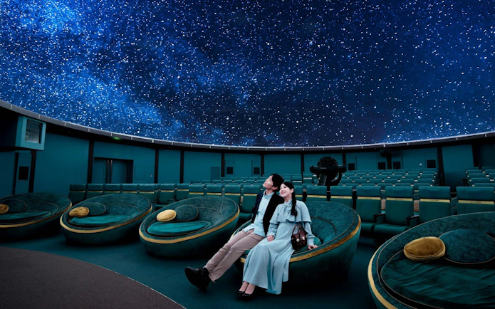 Couple enjoying starry sky at Konica Minolta Planetaria TOKYO Ginza.