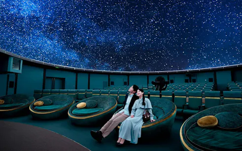 Couple enjoying starry sky at Konica Minolta Planetaria TOKYO Ginza.