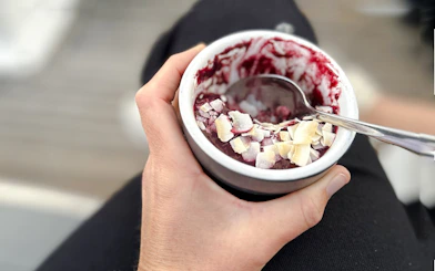 Dessert bowl with berry compote and coconut flakes on Auckland Harbour dinner cruise.