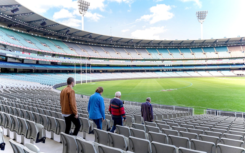 Visitors walking through Melbourne Cricket Ground on a guided sports tour.