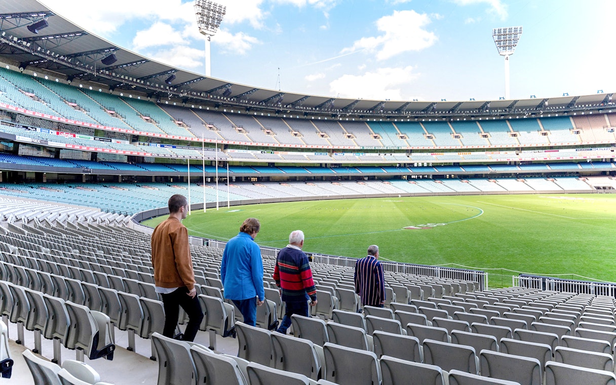 Visitors walking through Melbourne Cricket Ground on a guided sports tour.