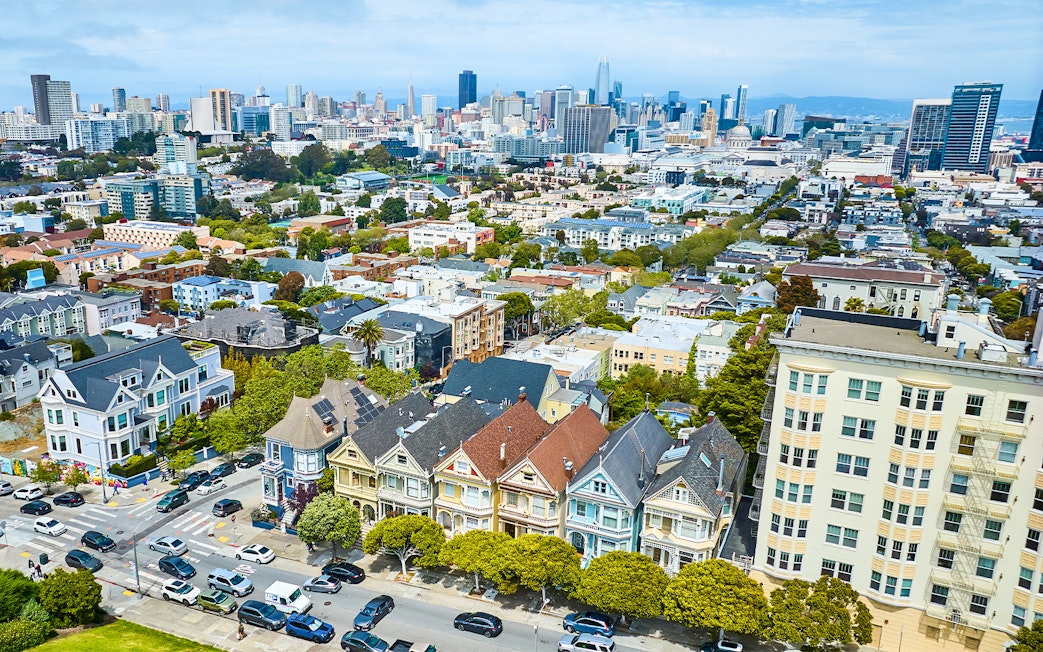 Aerial view of The Painted Ladies and San Francisco skyline during Golden Gate Bridge helicopter tour.