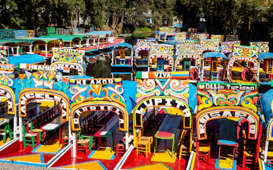 Colorful trajineras lined up in Xochimilco, Mexico City canal.