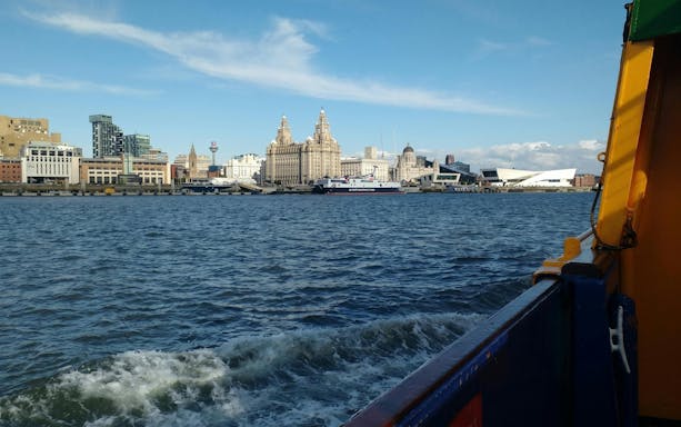 Mersey Ferries view of Liverpool waterfront with iconic buildings in the background.
