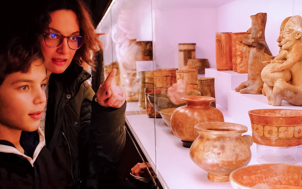 Boy and woman observing ancient artifacts at Chocolate Museum Paris.