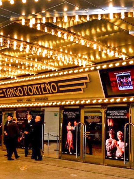 Tango Porteño theater entrance lit with marquee lights in Buenos Aires.