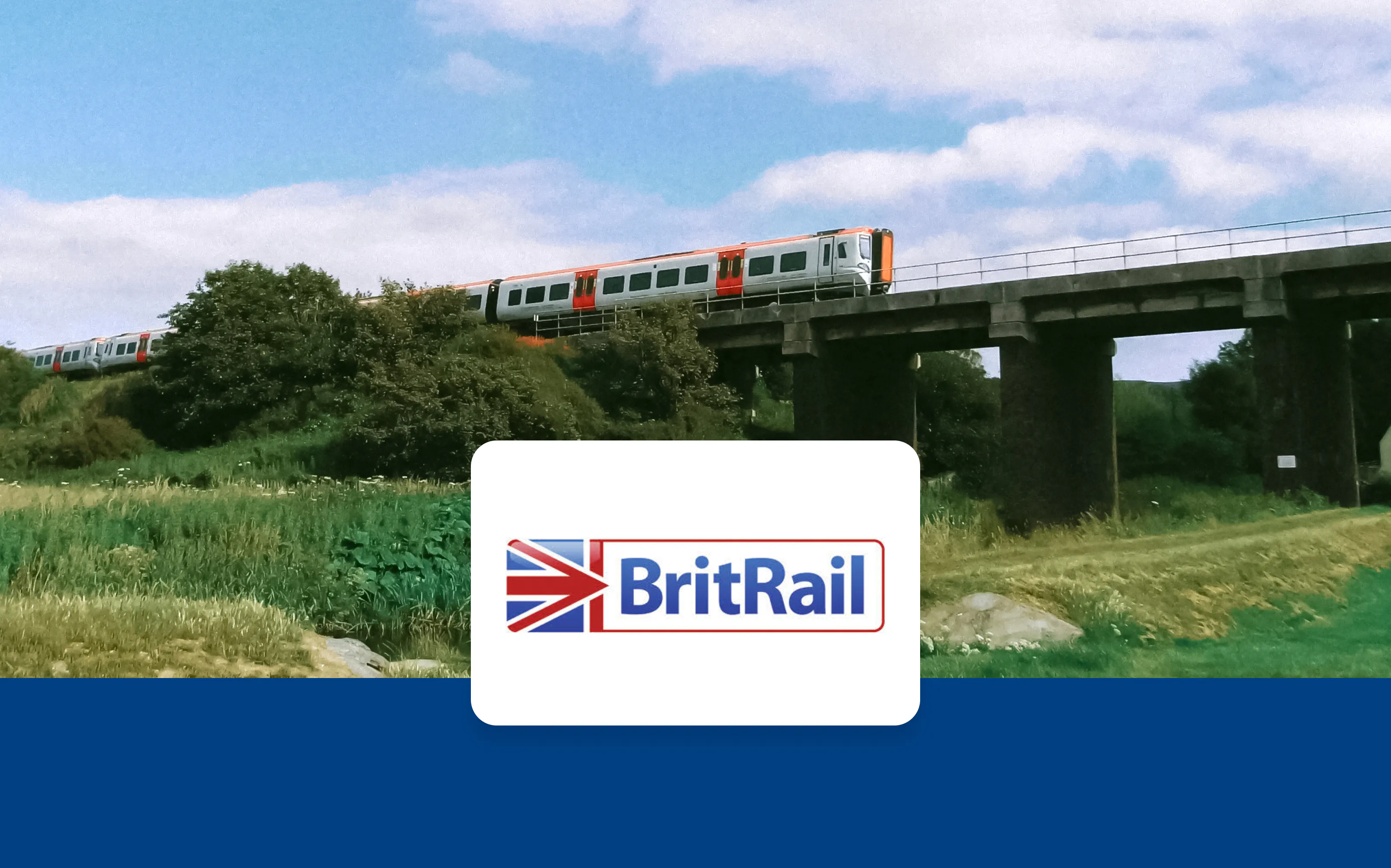 Train crossing a bridge in a rural landscape, BritRail logo in foreground.