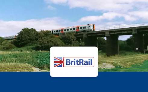 Train crossing a bridge in a rural landscape, BritRail logo in foreground.