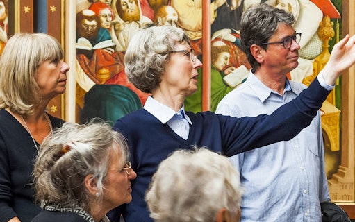 Group tour at Neues Museum viewing historical artwork.