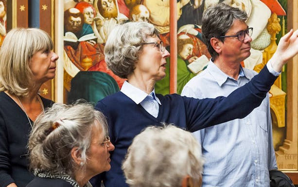 Group tour at Neues Museum viewing historical artwork.